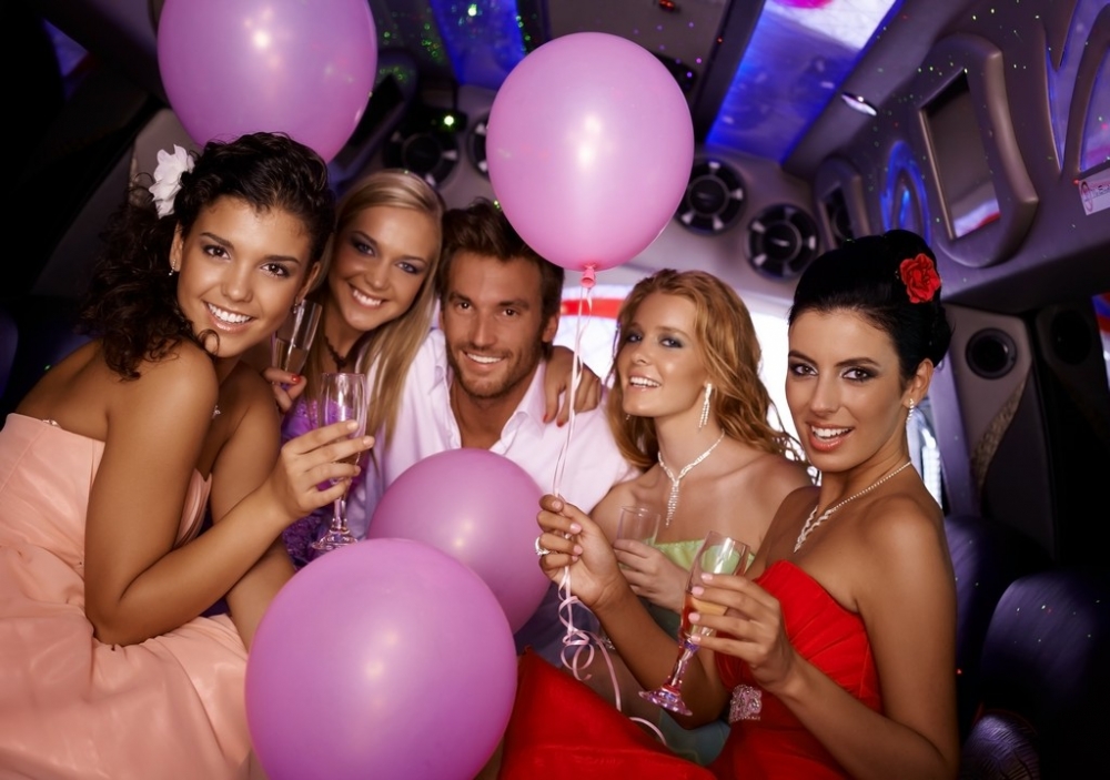 Attractive young people having party in limousine.